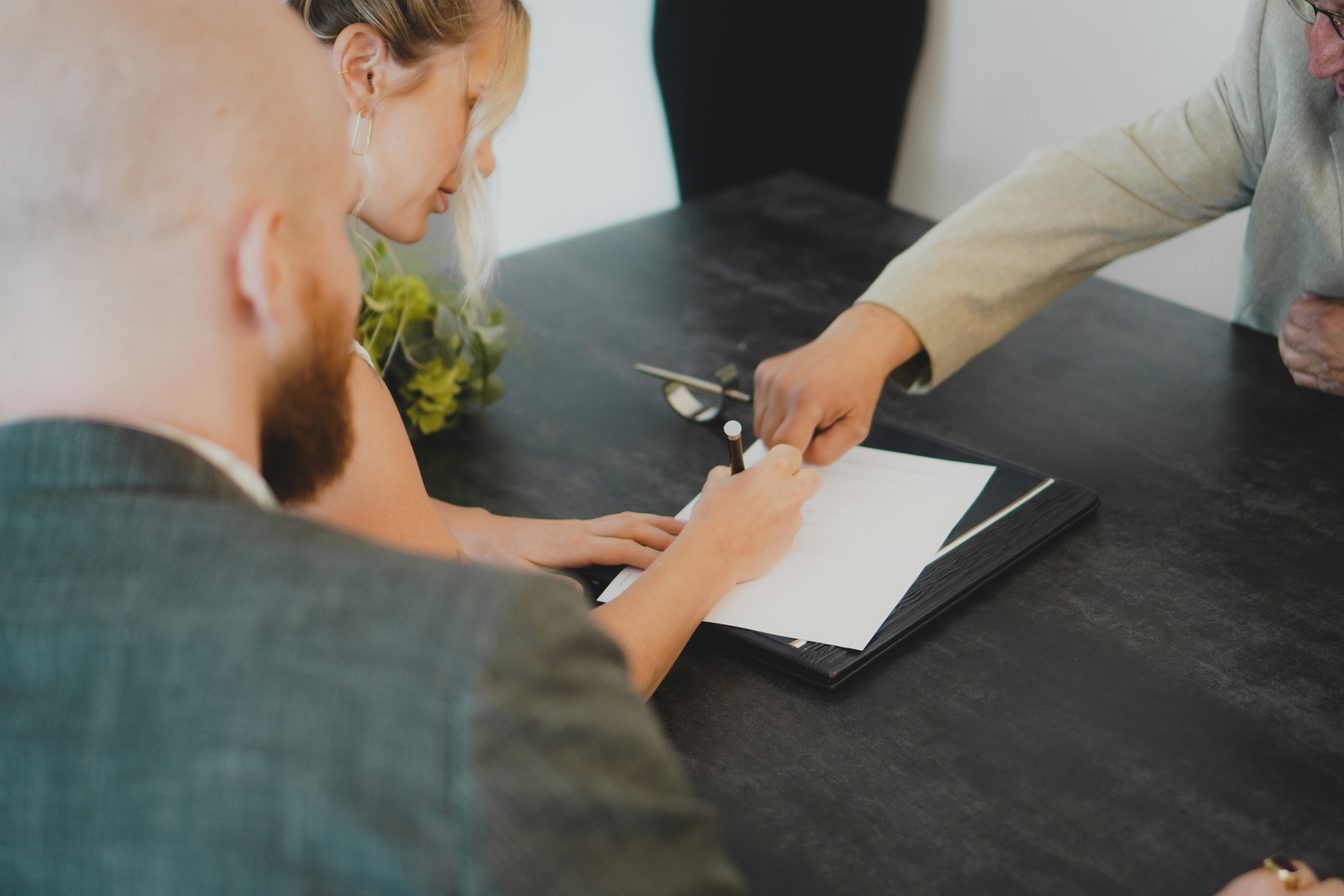 Real estate agent discussing a property appraisal with homeowners in East Auckland
